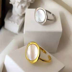 Shell design ring set with gold and platinum plating on display