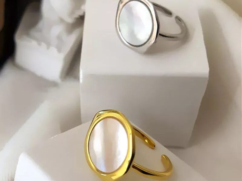 Shell design ring set with gold and platinum plating on display